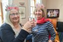 Cathy Low, left, and Julia Tucknott celebrate with a glass of bubbly at the Royal Findhorn Yacht Club.