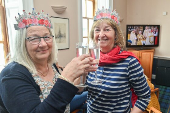 Cathy Low, left, and Julia Tucknott celebrate with a glass of bubbly at the Royal Findhorn Yacht Club.