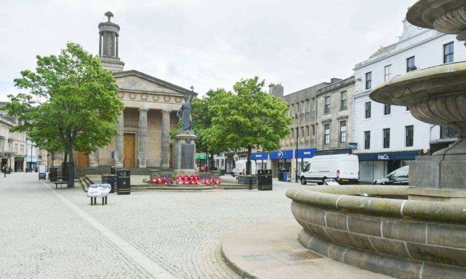 Elgin High Street with St Giles Church in background and fountain in foreground.