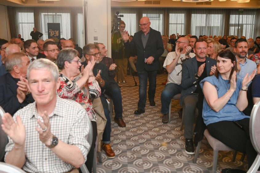 Aberdeen icon Willie Miller walking on stage to applause.