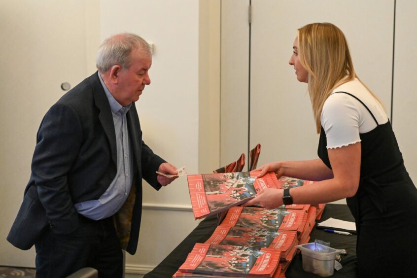 Guests snap up copies of the 80-page supplement.