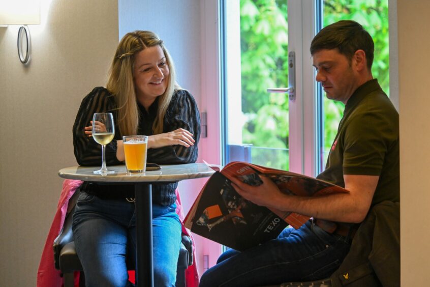 Subscribers with their souvenir Gothenburg publications in the bar area.