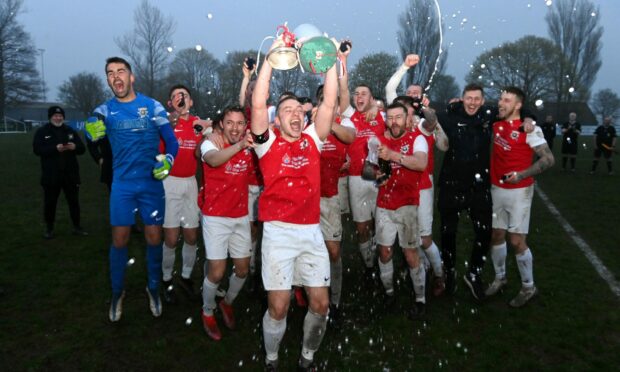 Culter celebrate their third trophy of the season. Image: Kenny Elrick/DC Thomson