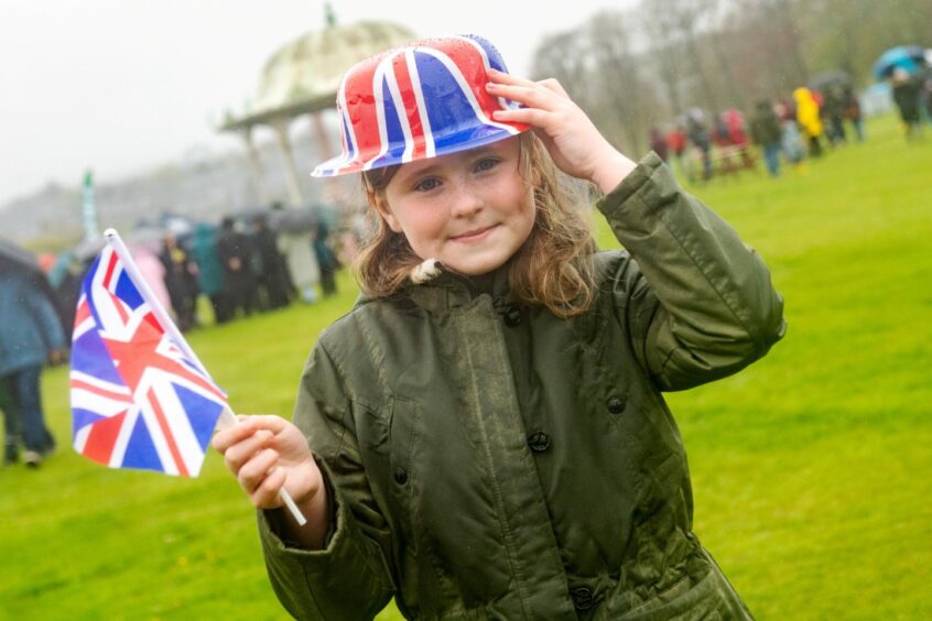 Maia Brooks with a Union Jack hat and flag at the coronation event.