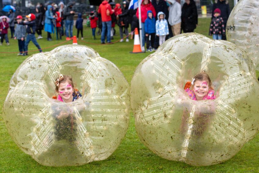 Hallie Rose, six, and Gracie Rose, four, taking part in the bodyzorbs at the coronation even at Duthie Park.