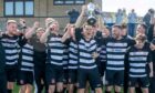 Sunnybank celebrate winning the North Region Junior Championship title, with captain Andy Mutch holding the trophy aloft. Image: Kath Flannery/DC Thomson.