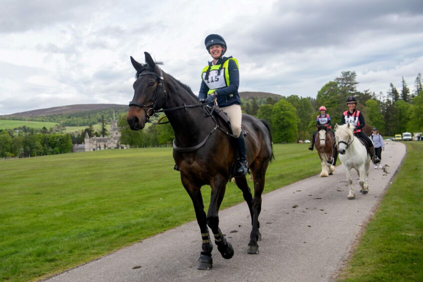 Riders with beautiful scenery of Balmoral Estate and Castle in the background.