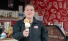 Shorty's owner Cheryl Anderson holding an ice cream cone in store.