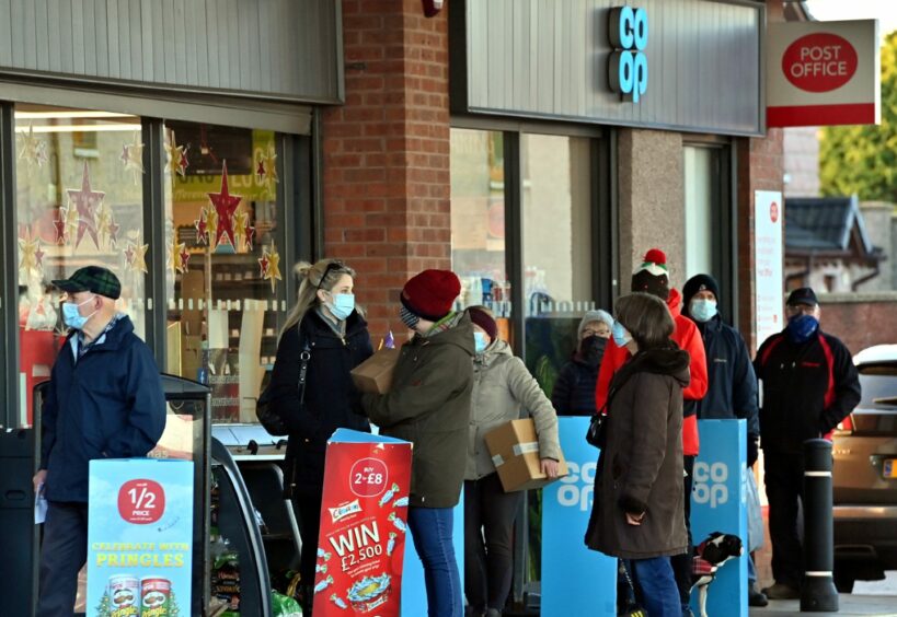 People seen queueing outside the Post Office at the Co-Op store in December 2020. 