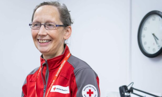 Headshot of Liz Tait wearing a red and grey British Red Cross jacket