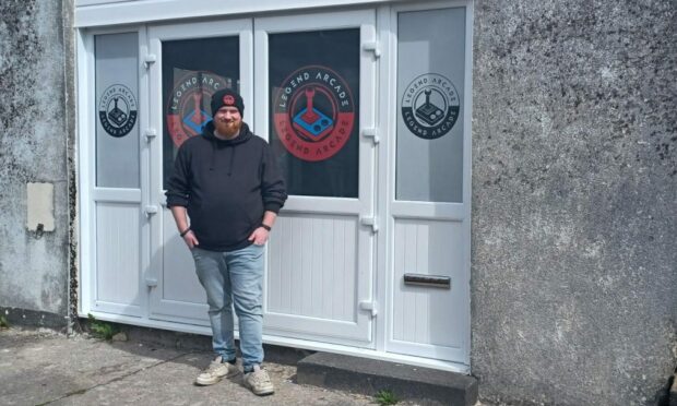 Mark Mackenzie stands outside of Legend Arcade, in the Plantation area of Fort William
