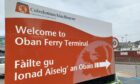 Oban ferry terminal sign in Gaelic and English. CMAL announces all ferries and harbours are to have Gaelic names.