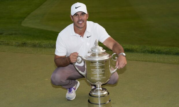 Brooks Koepka holds the Wanamaker trophy after winning the PGA Championship. Image: PA