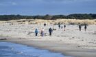 Walkers on Nairn Central Beach