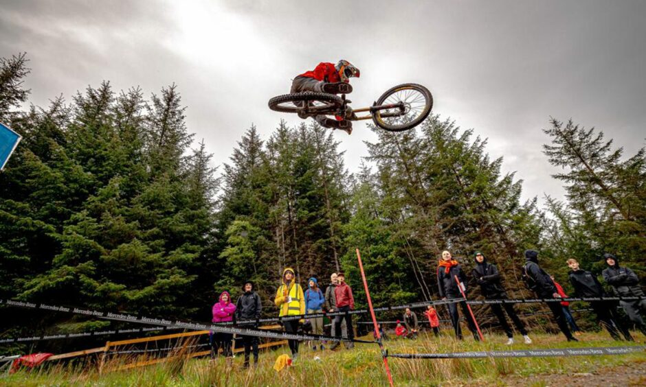 Young cyclist performs trick at a SDA mountain biking competition, Fort William