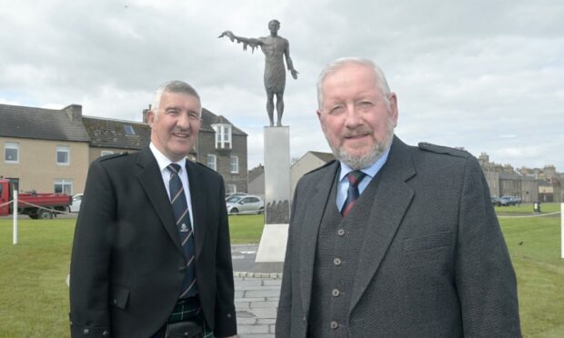 Willie Watt, (left) chairman of the Seafarers Memorial Group and sculptor Alan Beattie Herriot with the new memorial above Wick Harbour. Image Sandy McCook/DC Thomson