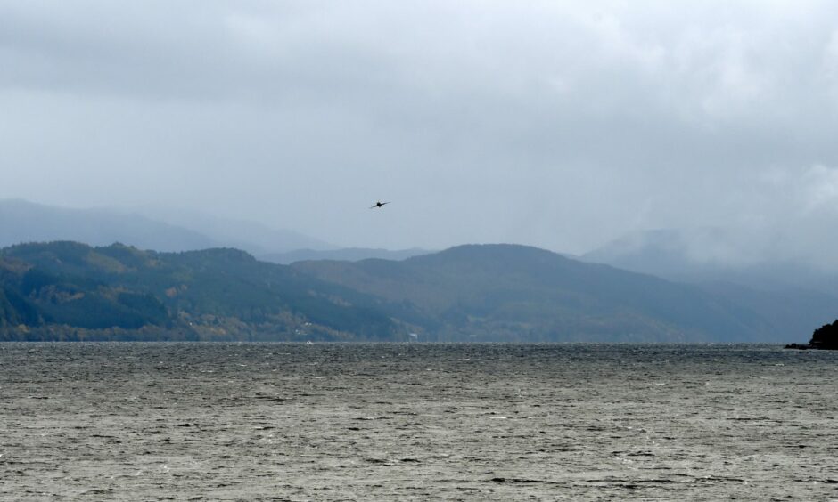A picture of a cloudy sky with Loch Ness.