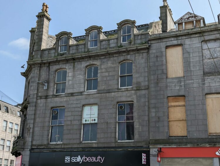 A rogue sign for Ambal's restaurant and plants sprouting from the roof above 167 Union Street is being looked at by Aberdeen's planning enforcement officers. Image: Alastair Gossip/DC Thomson.