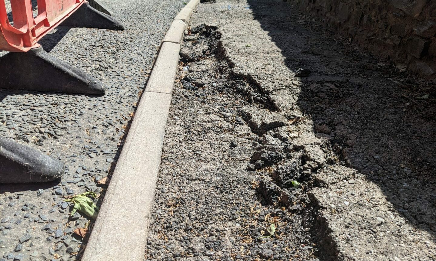 Worn pavement next to where sinkhole emerged. 