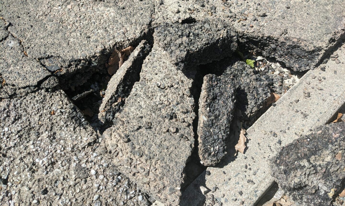 Close-up of cracked pavement on Fife Street. 