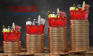 Tesco baskets on top of stacks of large coins to illustrate the increase in food prices in the UK.