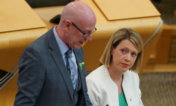 Transport Minister Kevin Stewart alongside former transport chief Jenny Gilruth at the Scottish Parliament. Image: PA.