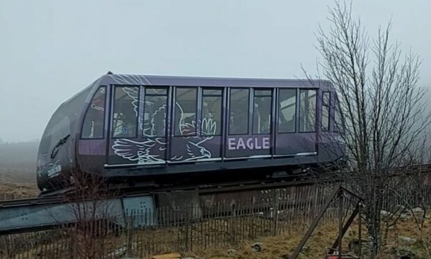 A carriage of the funicular railway makes its way along the tracks to the top of the mountain.