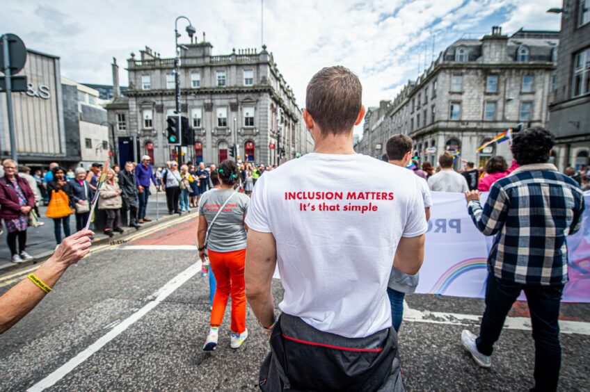 Man sporting a t-shirt that reads: "Inclusion matters, it's that simple".