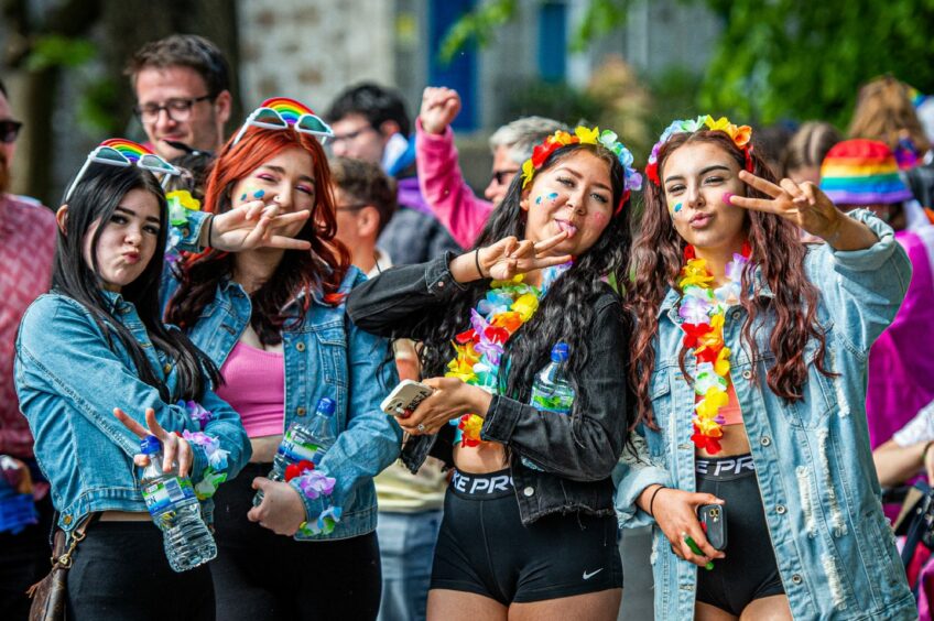 Group of girls posing for photos at Grampian Pride 2023.