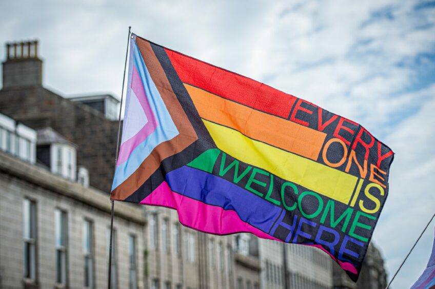 The rainbow flag at Grampian Pride 2023 that reads "Every one is welcome here"