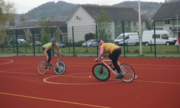 Players joust during the recent Great Glen Open bike polo event. Image Lizzy Wood