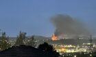 Fire in the distance with smoke billowing from the caravan in Bucksburn.