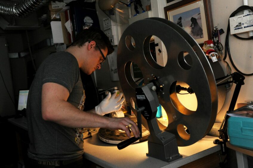Projector Ian Cushnie at the reel as the Belmont Cinema gave visitors a look behind the scenes on Doors Open Day in 2015. Image: Kath Flannery/DC Thomson.