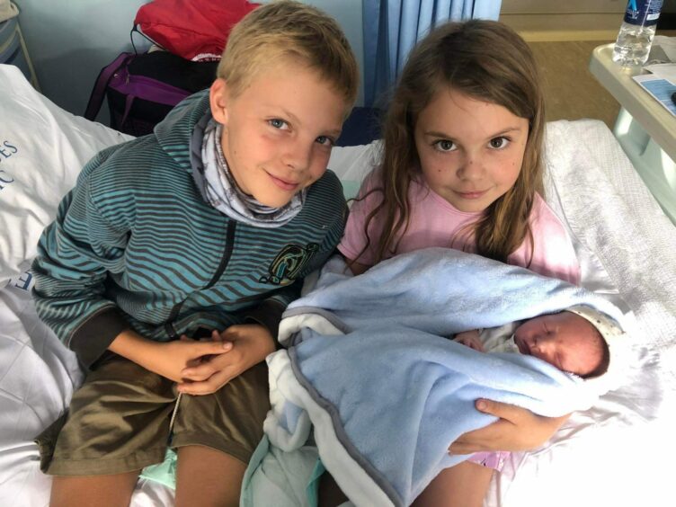 Ashton and Eliana with their brother Callen after he was born.