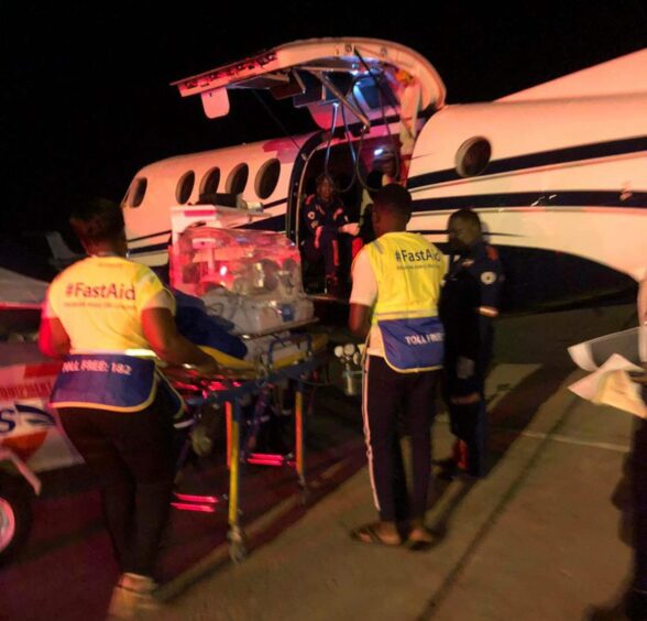 Baby Callen being taken into an air ambulance to travel to Johannesburg, South Africa for treatment.