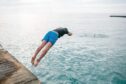 Pier jumping is a common sight in summer in Orkney. Image: Shutterstock