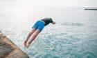 Pier jumping is a common sight in summer in Orkney. Image: Shutterstock
