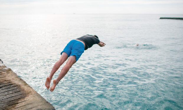 man jumping into water