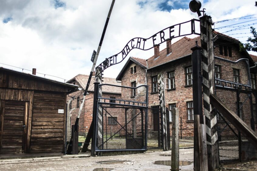 The main gate of the concentration camp in Auschwitz with the inscription 'work makes you free'.