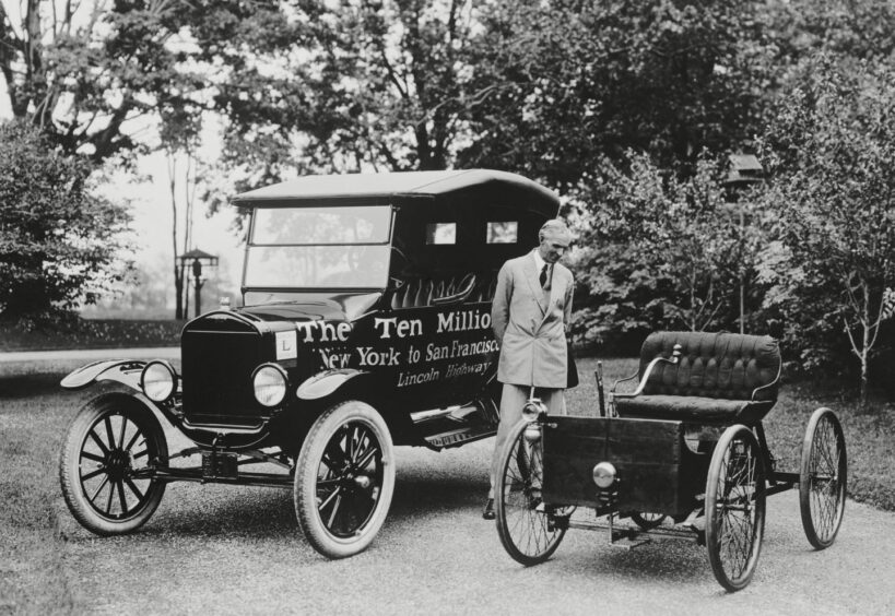 Henry Ford stands between the first and ten millionth Ford, June 4, 1924.