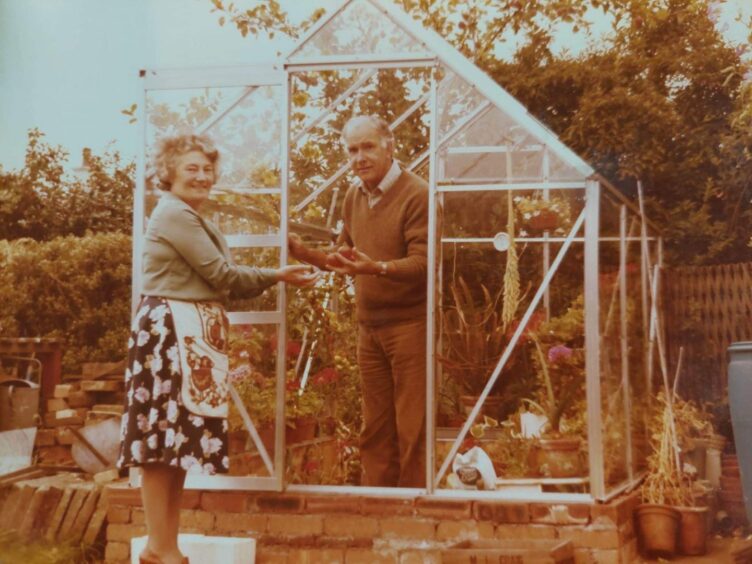 Elizabeth Bonner with her husband Frank Bonner in their greenhouse. 