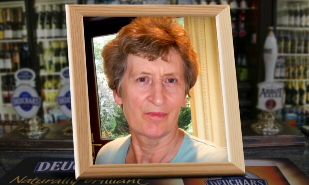 A headshot of Doris MacKenzie wearing duck egg blue, surrounded by a wooden picture frame is shown with a scene from a public house in the background.