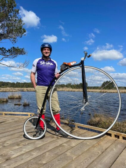 Tom Clowes stands beside his penny farthing ahead of cycling the Hebridean Way in May
