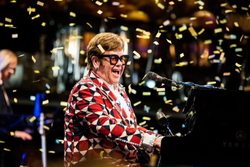 Elton John performing on stage.