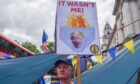 A protester holds a sign mocking Boris Johnson as anti-Tory and anti-Brexit activists stage their weekly protest in Westminster. Image: Vuk Valcic/ZUMA Press Wire/Shutterstock.