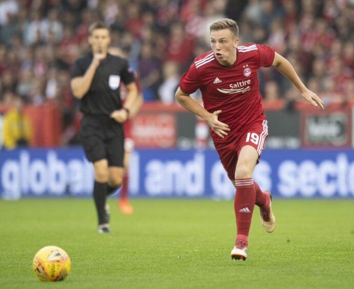 Lewis Ferguson on the run for the Dons against Burnley in a Europa League qualifying clash, kitted out in the 2018/19 club strip.