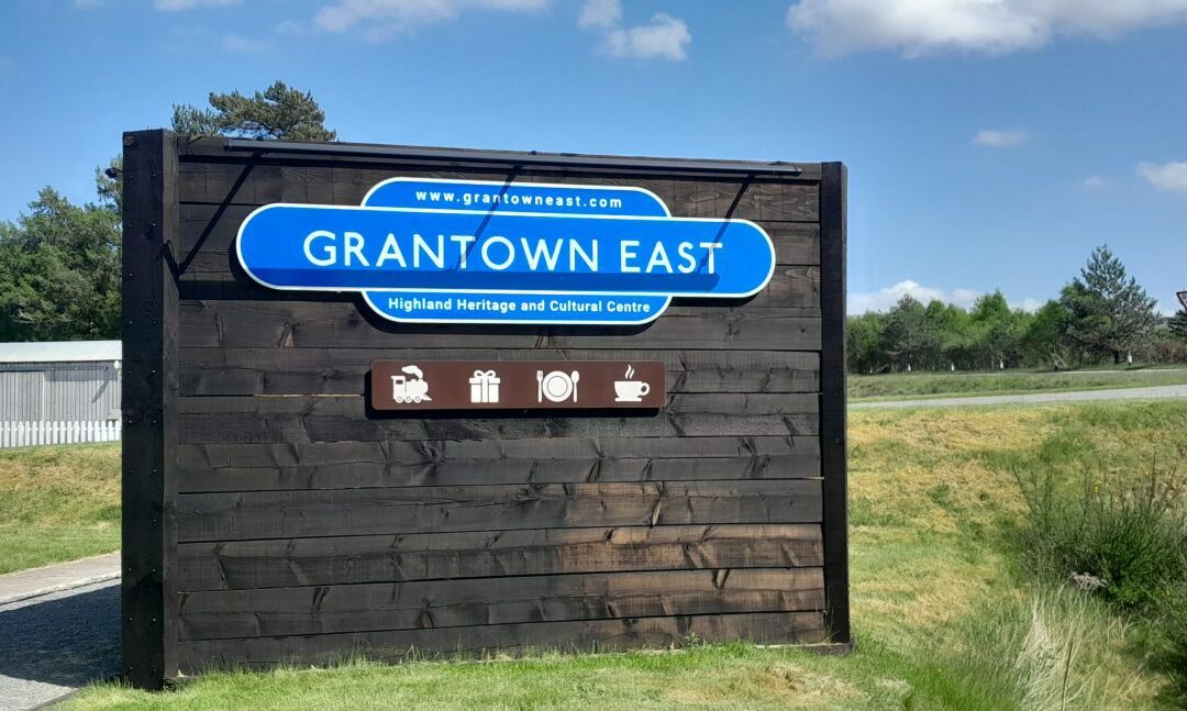 Old-style British Railway blue sign saying Grantown East