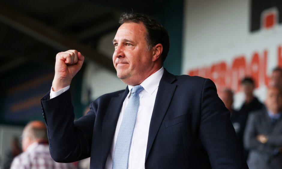 Ross County boss Malky Mackay with his fist in the air