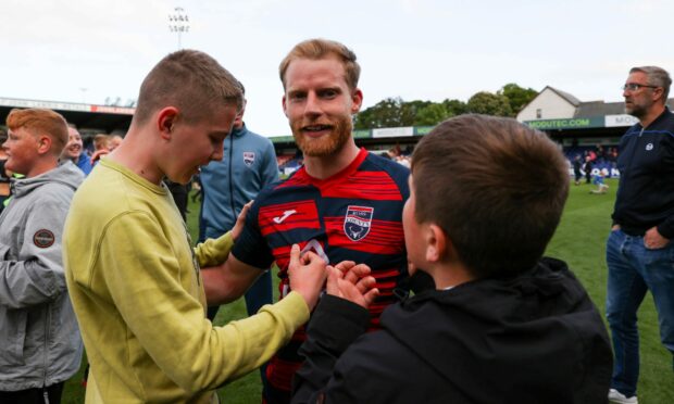 Josh Sims celebrates with Ross County supporters following the play-off victory over Partick Thistle. Image: SNS