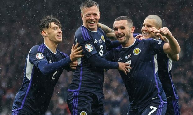 Scotland's Callum McGregor celebrates  with John McGinn (second from right) after making it 1-0 against Georgia. Image: SNS